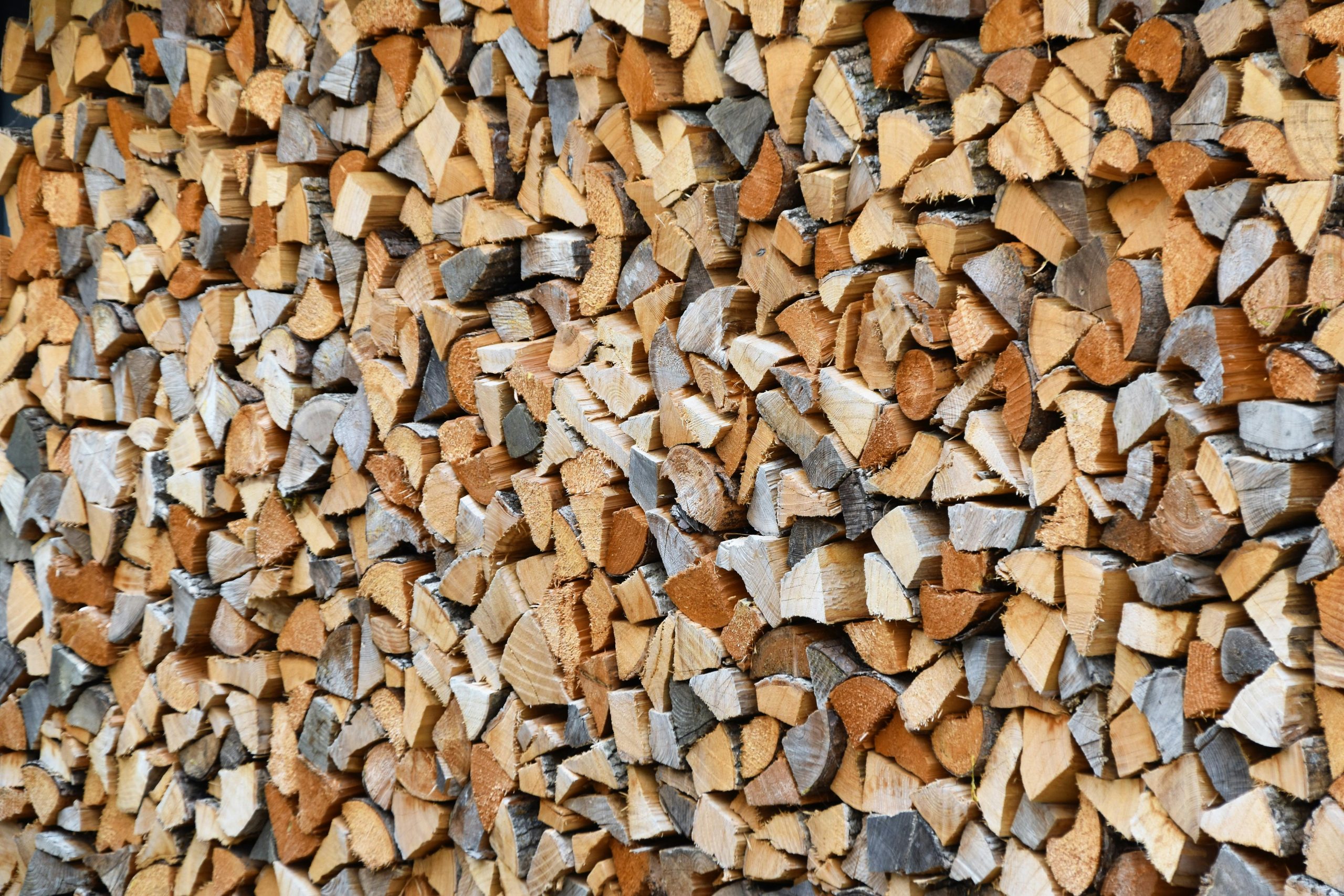 Neatly arranged stack of split firewood, perfect for cold winter days.
